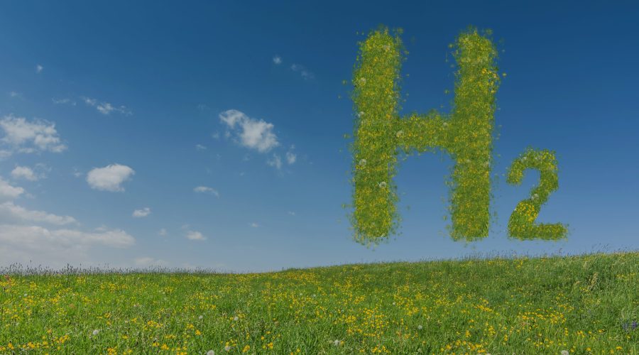 green hydrogen h2 letters hovers over a freh meadow with sky green hydrogen h2 letters hovers over a freh meadow with blue sky
